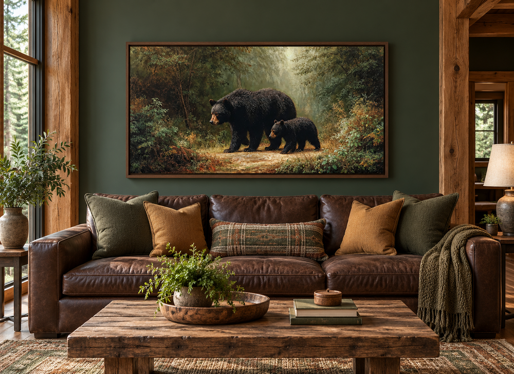 Black mama bear and cub walking in a forest canvas wall art above a brown leather sofa.