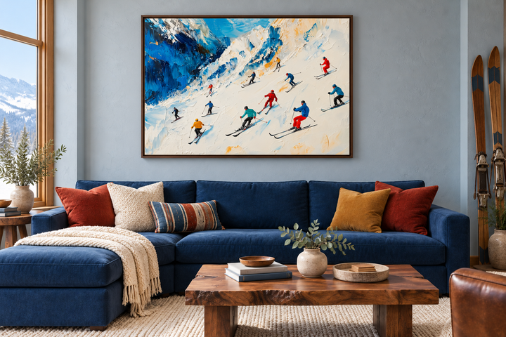 Colorful Skiers on Mountain Slope Framed Canvas Wall Art above a blue sofa in a cozy living room.