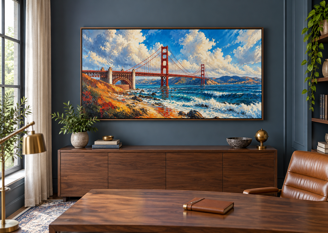 Framed oil painting of the Golden Gate Bridge in a modern office with a walnut desk and blue walls.