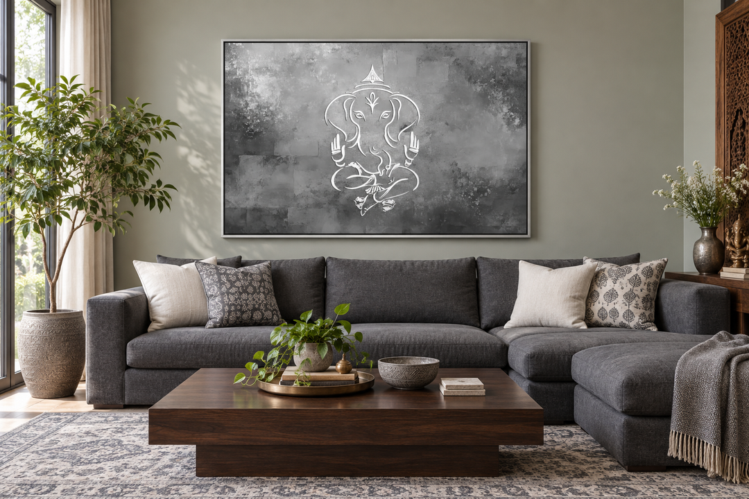 Minimalist Lord Ganesh framed canvas wall art in grey, silver, and white above a grey sectional sofa.