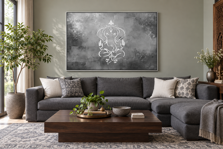 Minimalist Lord Ganesh framed canvas wall art in grey, silver, and white above a grey sectional sofa.