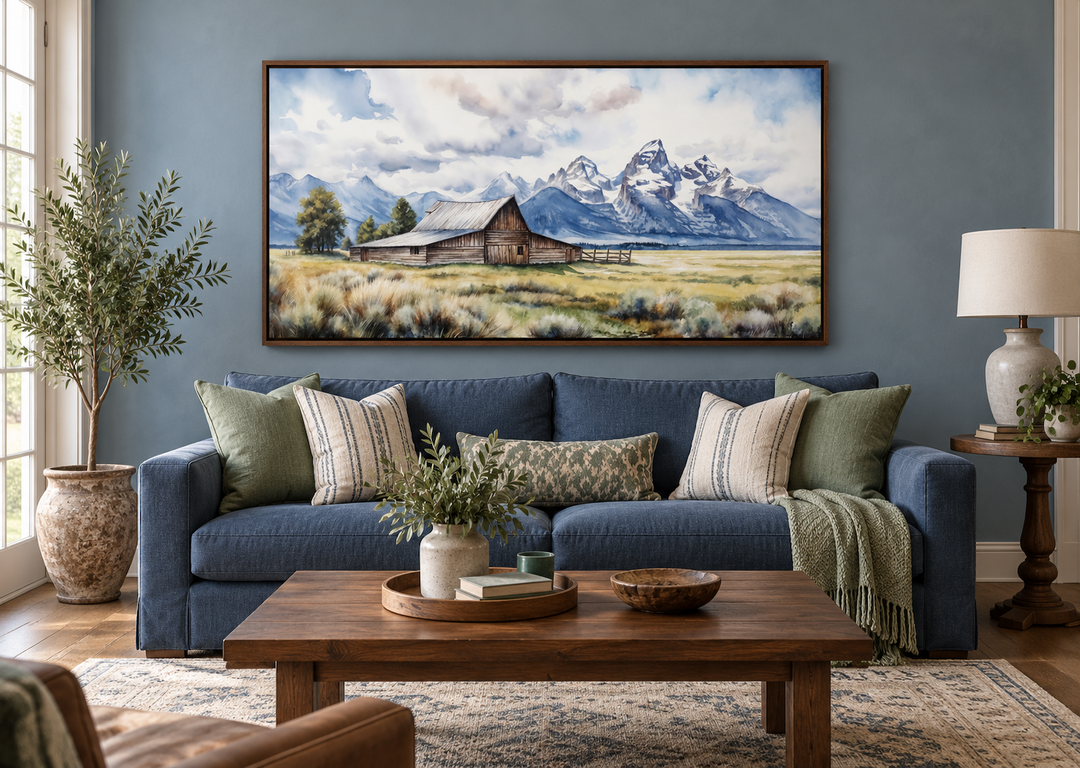 Framed Moulton Barn canvas wall art above a blue sofa in a rustic farmhouse living room.