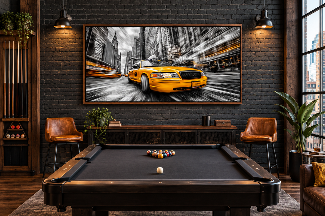 New York City yellow taxi graffiti style canvas wall art in a walnut frame above a pool table.