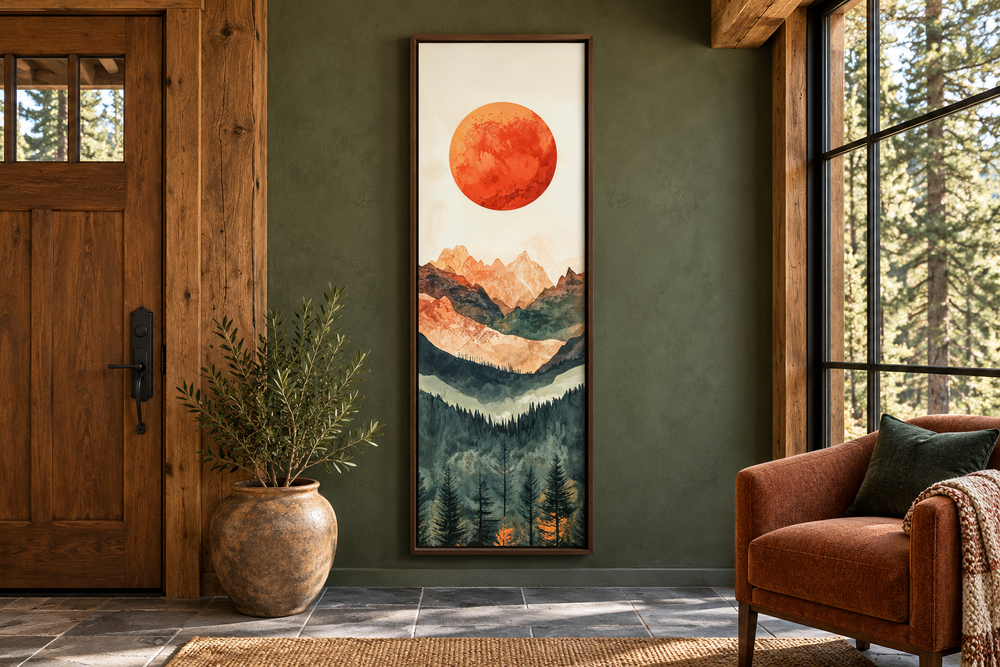 Tall narrow vertical canvas art of a red sun over layered mountains and forest in a cabin entryway.