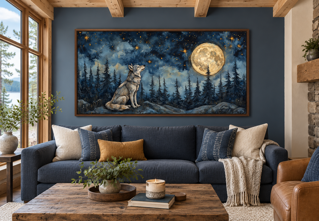 Wolf wall art canvas under a full moon in a night forest, framed above a blue sofa in a rustic room.