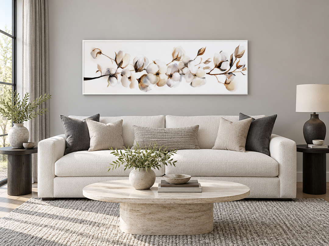 Boho long horizontal neutral cotton plant painting on canvas above a white sofa in a living room.