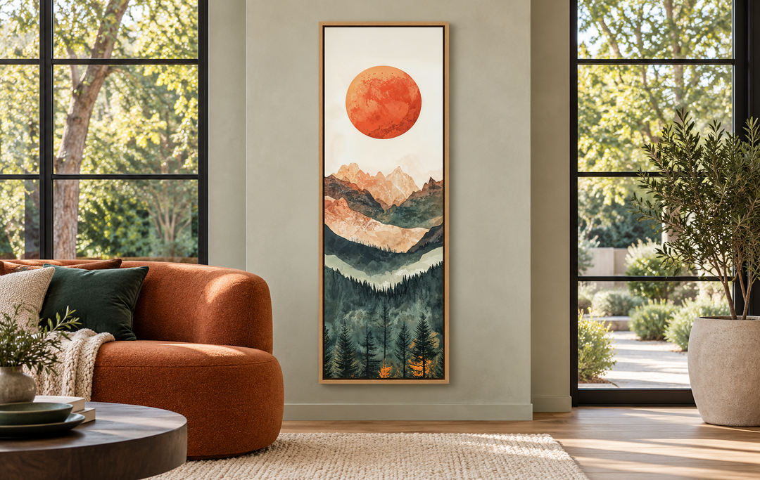 Tall narrow vertical canvas wall art of a red sun over layered mountains and a pine forest.