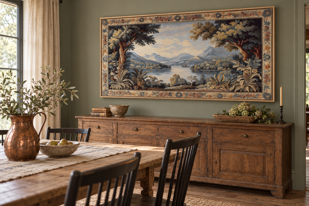 Antique River Landscape Framed Tapestry Canvas Wall Art above a rustic wooden sideboard.