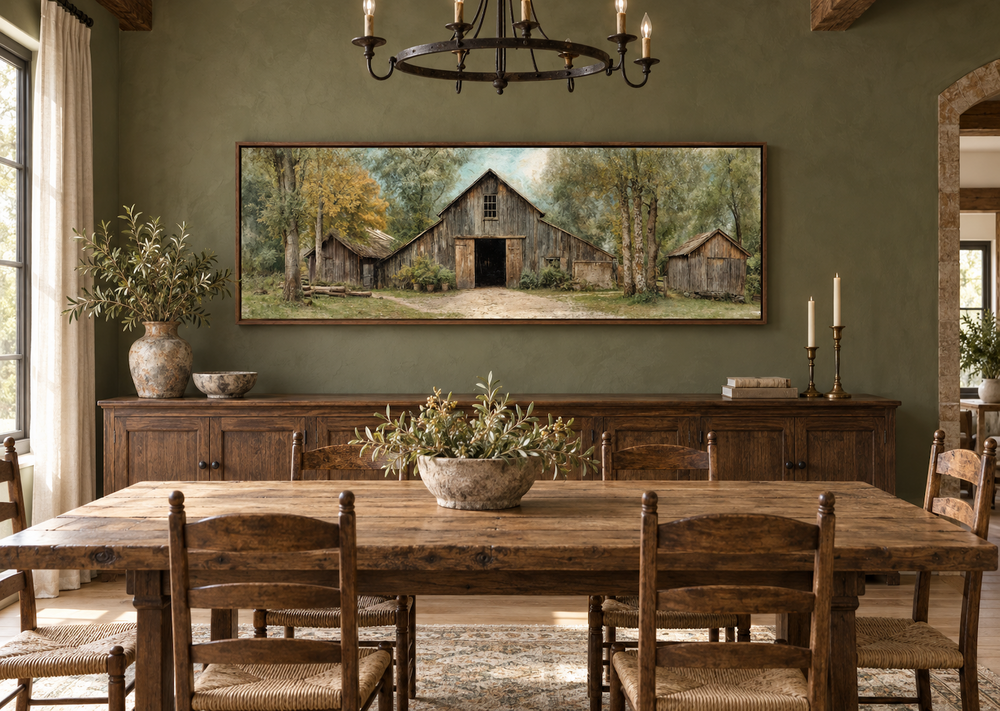 Rustic barn wall art in a walnut frame above a wooden dining table in a farmhouse-style room.