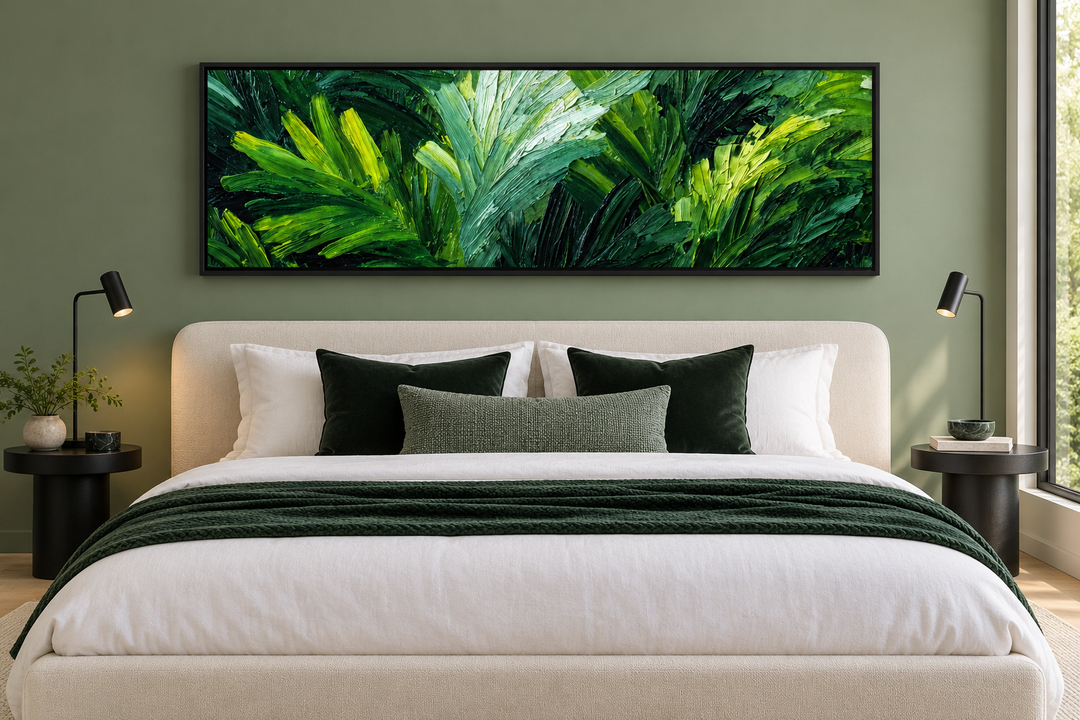 Rainforest Jungle Leaves long horizontal canvas print above a bed in a modern sage green bedroom.