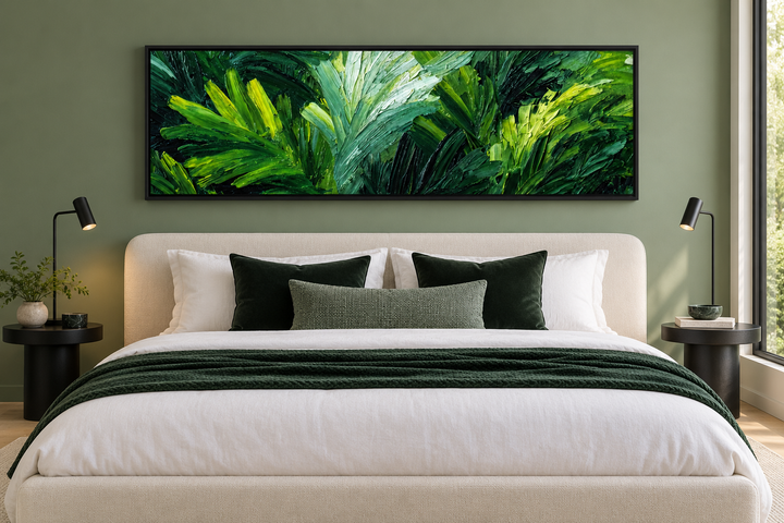 Rainforest Jungle Leaves long horizontal canvas print above a bed in a modern sage green bedroom.