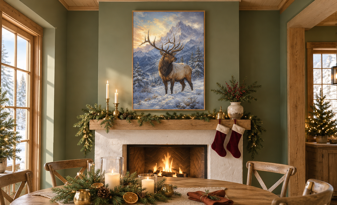 Elk in snowy mountains framed canvas wall art hanging above a fireplace in a cozy winter cabin.