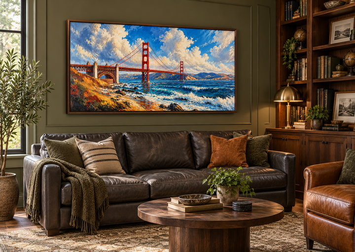 Framed oil painting of the Golden Gate Bridge above a leather sofa in a dark green library.