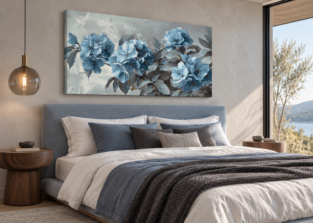 Large horizontal canvas print of abstract blue flowers on a grey background above a modern bed.