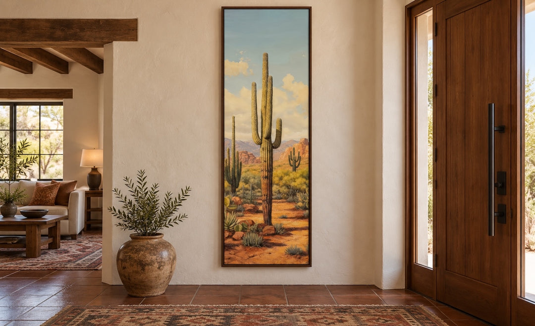 Tall vertical saguaro cactus canvas wall art in a narrow walnut frame in a Southwestern entryway.