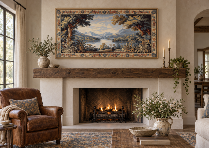 Antique river landscape framed tapestry canvas wall art hanging above a rustic wooden fireplace.
