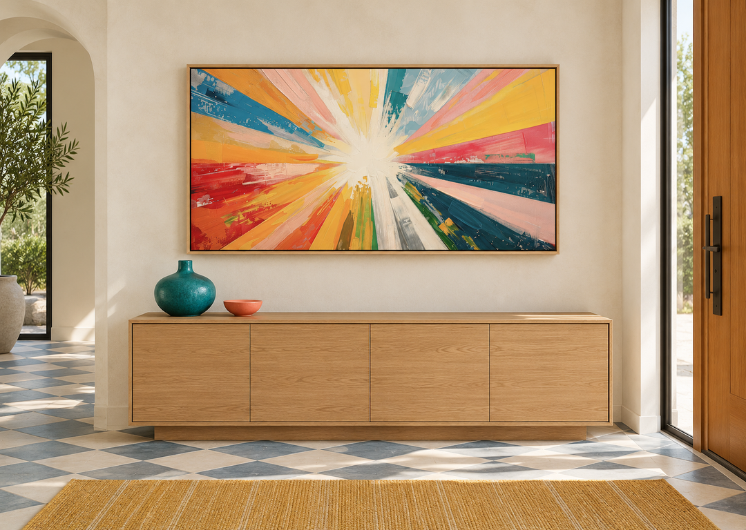 Boho sun rays wall art with multicolored rays in an oak frame above a wooden sideboard.