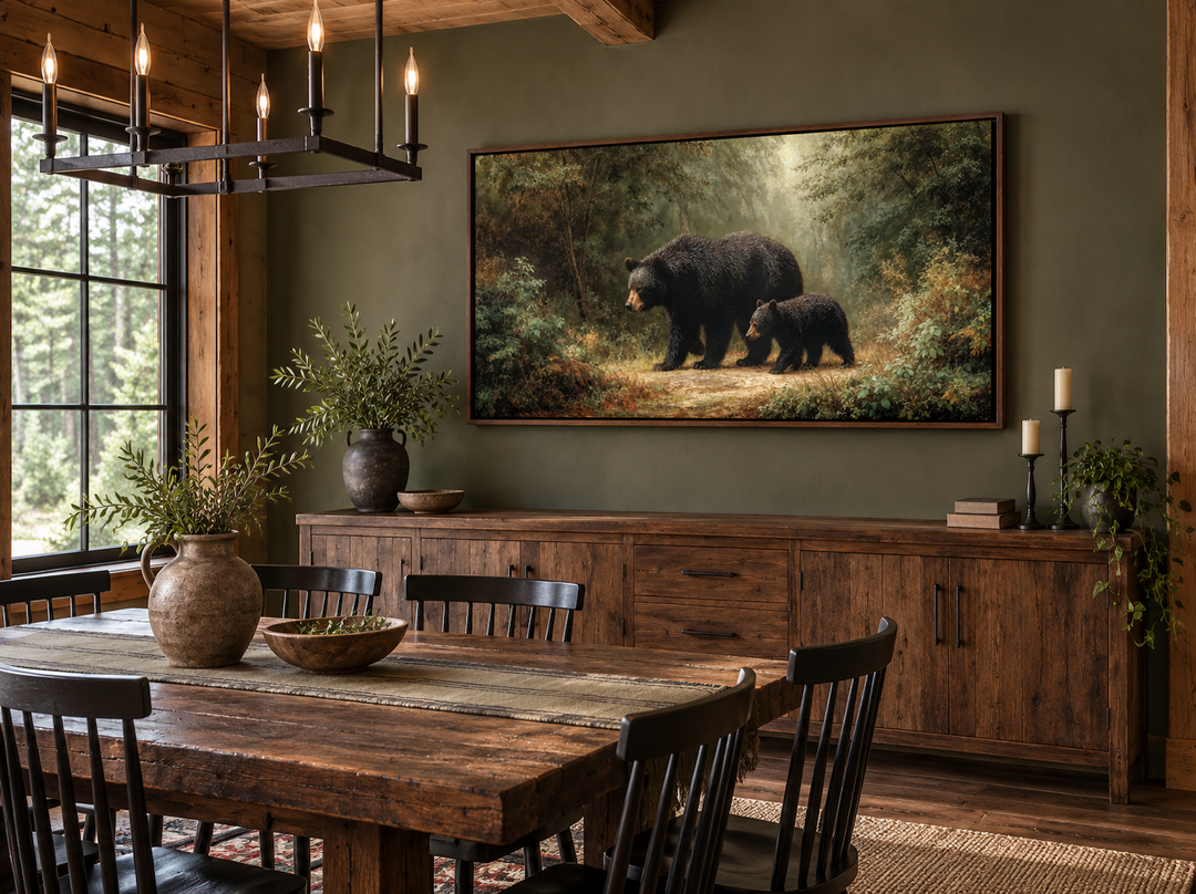 Black mama bear and cub walking in a forest canvas wall art above a wooden sideboard.