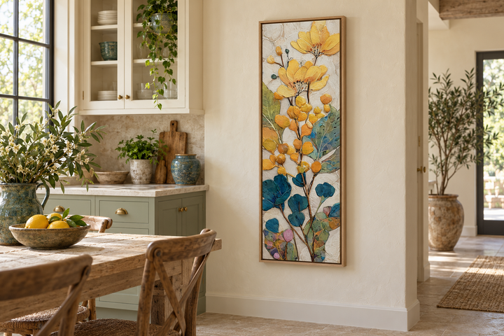 Tall narrow vertical canvas wall art with yellow and blue floral botanical design in a wood frame.