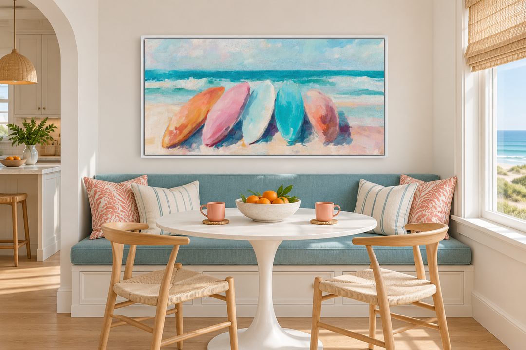 Coastal canvas wall art with pastel surfboards in a white frame above a beachy breakfast nook.