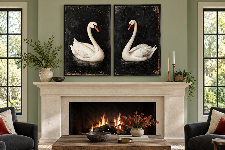 Set of 2 framed canvas wall art featuring antique white swans on a black background over a fireplace.