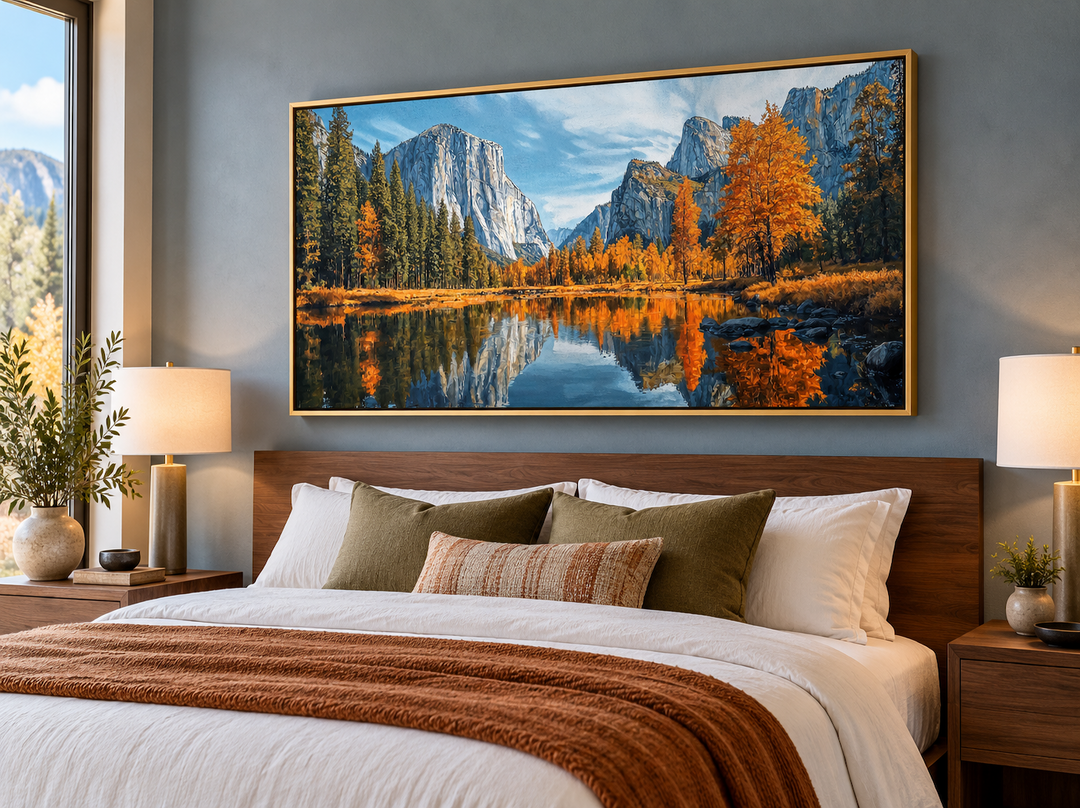 Framed canvas painting of Yosemite National Park in autumn hanging above a bed in a modern bedroom.