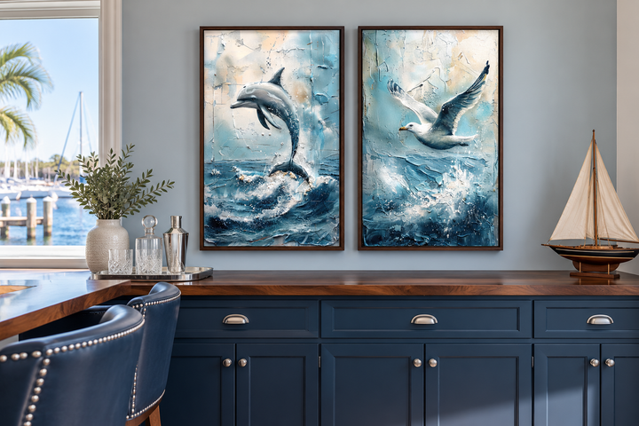 Set of 2 abstract coastal framed canvas wall art featuring a dolphin and a seagull over ocean waves.