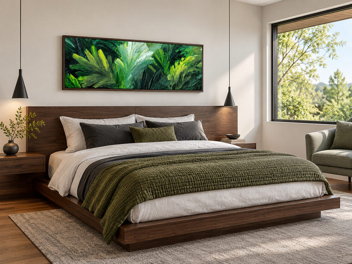 Panoramic rainforest jungle leaves wall art in a dark wood frame above a modern platform bed.