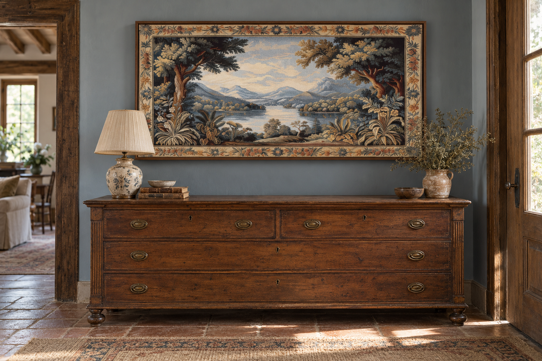 Antique river landscape framed tapestry canvas wall art hanging above a wooden dresser.