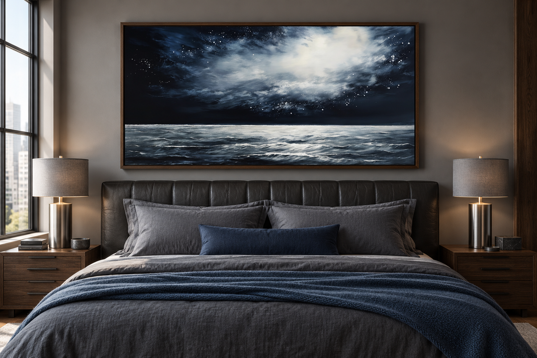 Dark horizontal starry night ocean seascape framed canvas wall art hanging above a bed.