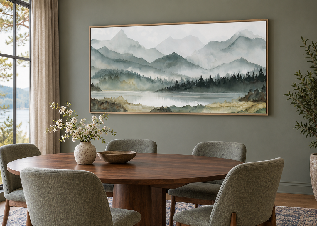 Sage green mountain lake landscape framed canvas wall art above a dining table.