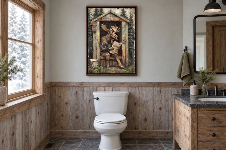 Moose in a wooden outhouse reading a newspaper wall art in a rustic bathroom with wood paneling.