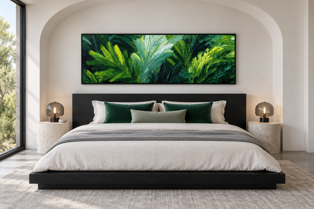 Rainforest Jungle Leaves horizontal canvas print above a black bed frame in a modern bedroom.