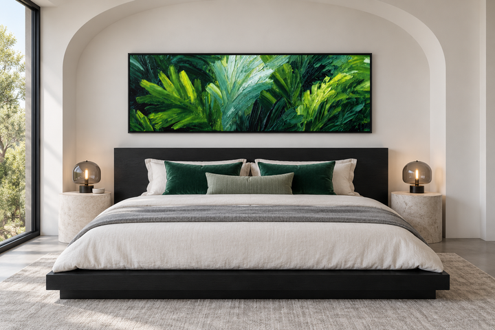 Rainforest Jungle Leaves horizontal canvas print above a black bed frame in a modern bedroom.