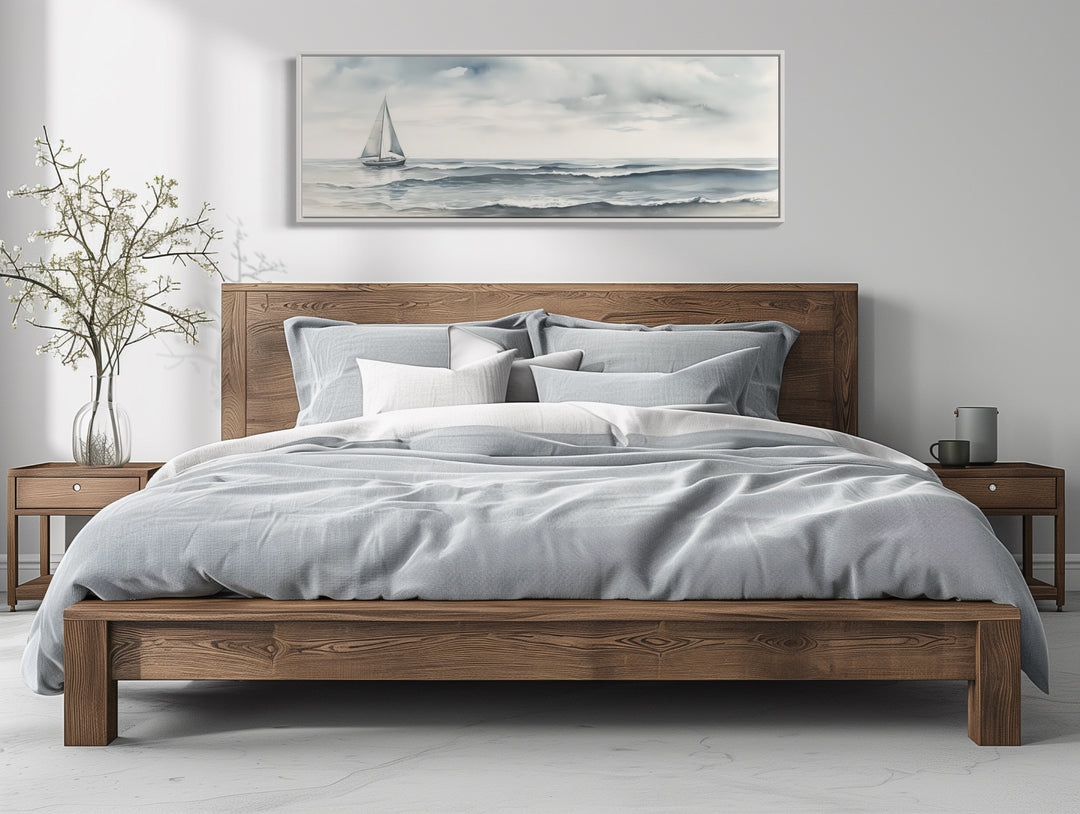 Grey Ocean And Sail Boat Coastal Horizontal Canvas Wall Art above wooden bed