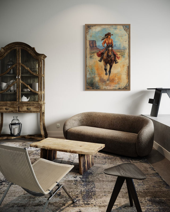 Cowgirl Riding A Horse In Monument Valley Framed Canvas Wall Art in living room