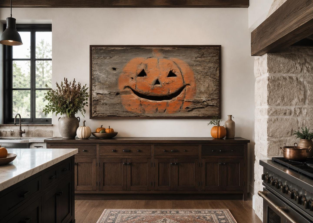 Primitive pumpkin canvas wall art on weathered wood background in a rustic farmhouse kitchen.