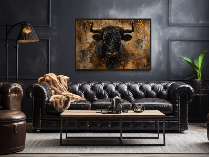 Charging Bull Head on Gold and Black Framed Canvas Wall Art in a living room with a couch