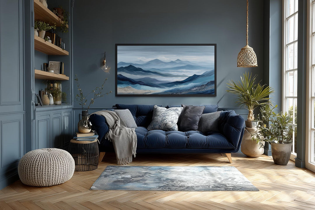 Blue mountain serene nature landscape canvas wall art above a navy sofa in a dark blue living room.