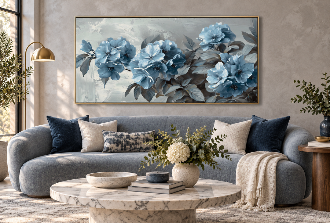 Abstract light blue floral canvas wall art with a modern grey background above a blue sofa.