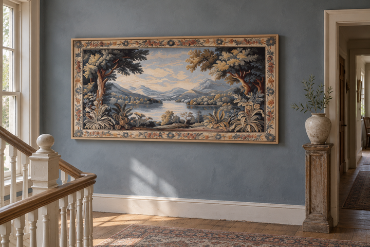 Antique river landscape framed tapestry canvas wall art on a blue wall in a home interior.