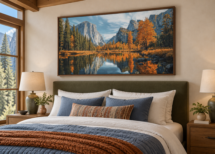 Framed Yosemite National Park painting on canvas above a bed in a rustic bedroom.