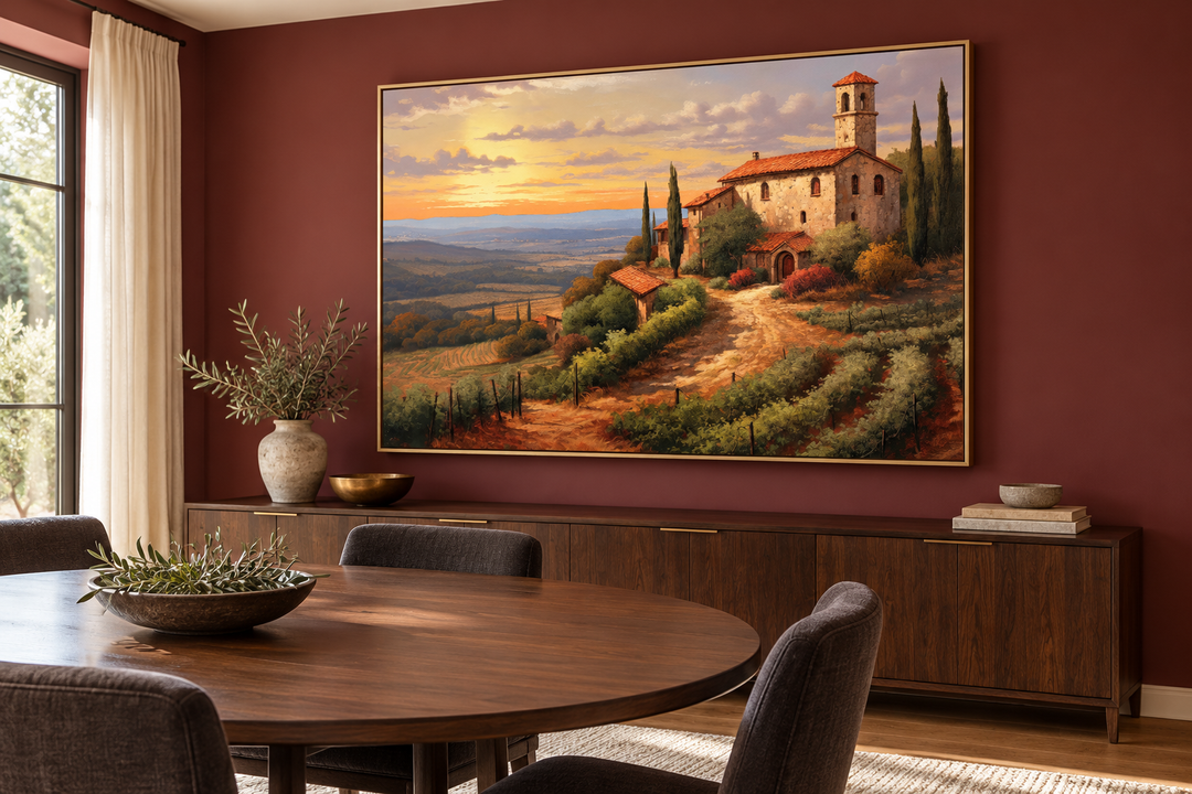 Rolling hills of Tuscany framed canvas wall art in a gold frame above a wooden sideboard.