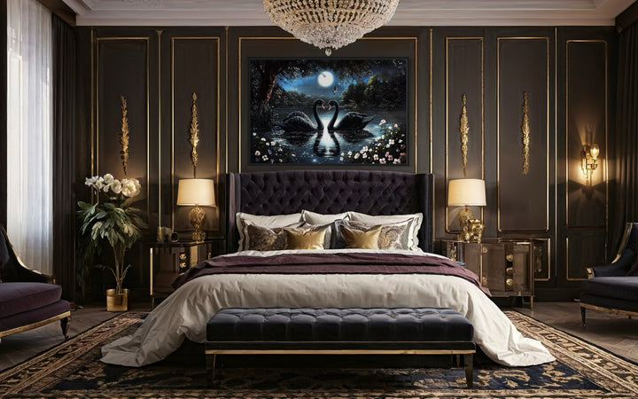 Two Black Swans In The Lake At Night Under Full Moon Romantic Framed Canvas Wall Art in a bedroom with a large bed and a chandelier