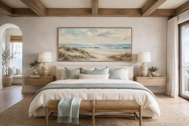 Wide horizontal wall art of sandy beach dunes, sea grass, and rolling waves in a slim gold frame.