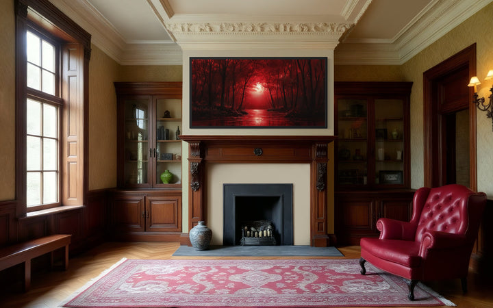 Red Forest And Moon Landscape Framed Canvas Wall Art in a living room with a red chair and a fire place