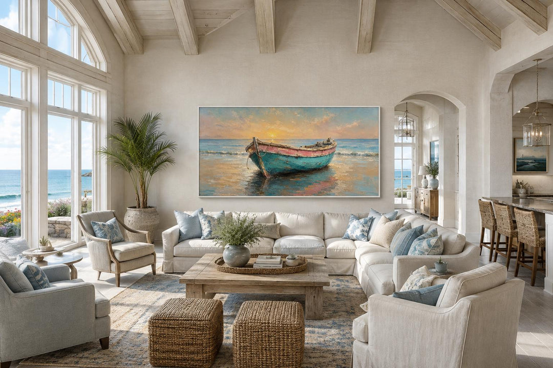 Weathered rowboat wall art in a coastal living room with a white sectional and ocean views.