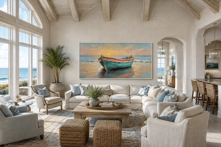 Weathered rowboat wall art in a coastal living room with a white sectional and ocean views.
