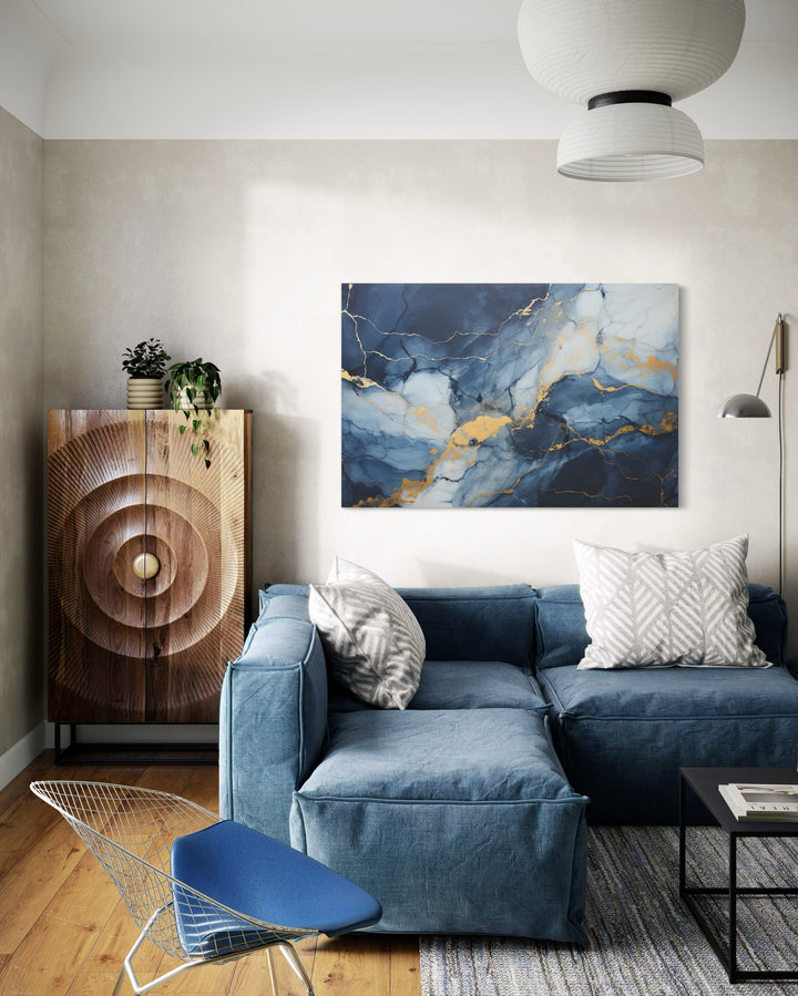 Navy Blue Grey Gold Abstract Marble Canvas Wall Art in a living room with a blue couch