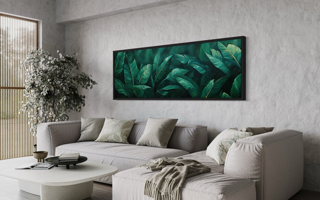 Green Tropical Leaves Long Narrow Horizontal Framed Canvas Wall Art in living room with grey couch